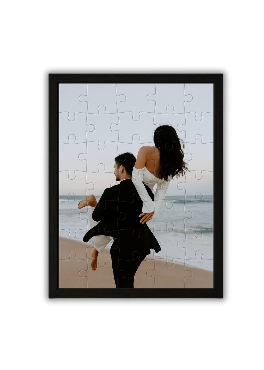 wooden personalized puzzle featuring a romantic couple walking by the ocean at sunset framed in black